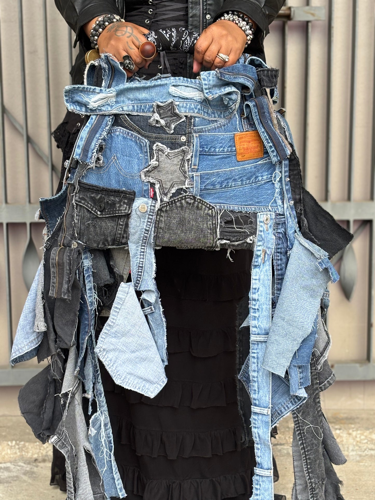 Woman holding denim bag with stars and patches , bandanna handle
