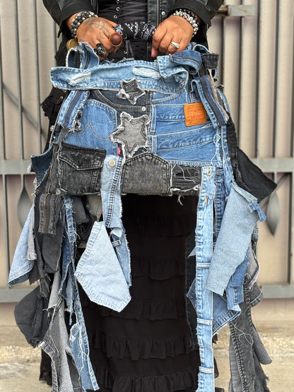 Woman holding denim bag with stars and patches , bandanna handle

