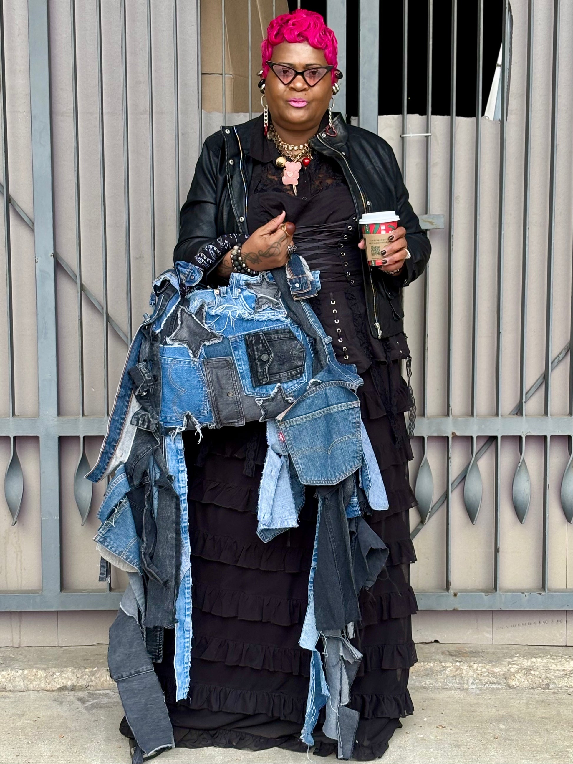 Woman holding denim bag with stars and patches , bandanna handle

