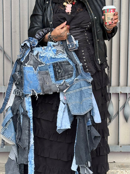 Woman holding denim bag with stars and patches , bandanna handle
