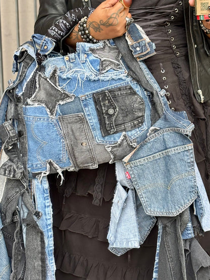 Woman holding denim bag with stars and patches , bandanna handle
