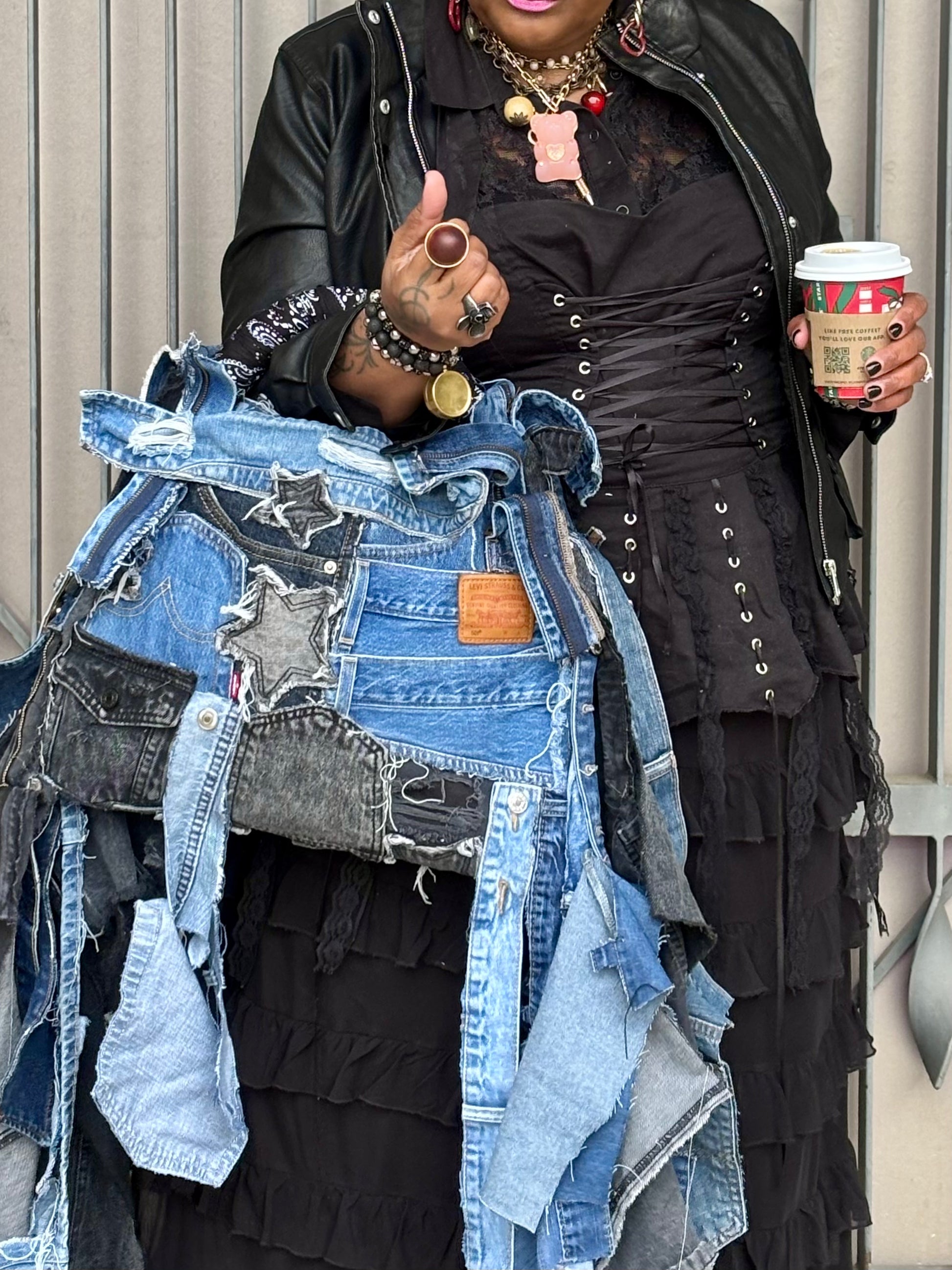 Woman holding denim bag with stars and patches , bandanna handle
