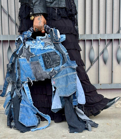 Woman holding denim bag with stars and patches , bandanna handle
