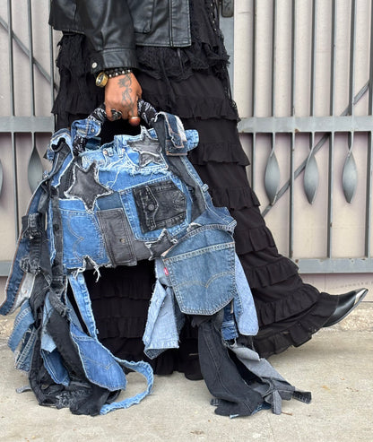 Woman holding denim bag with stars and patches , bandanna handle

