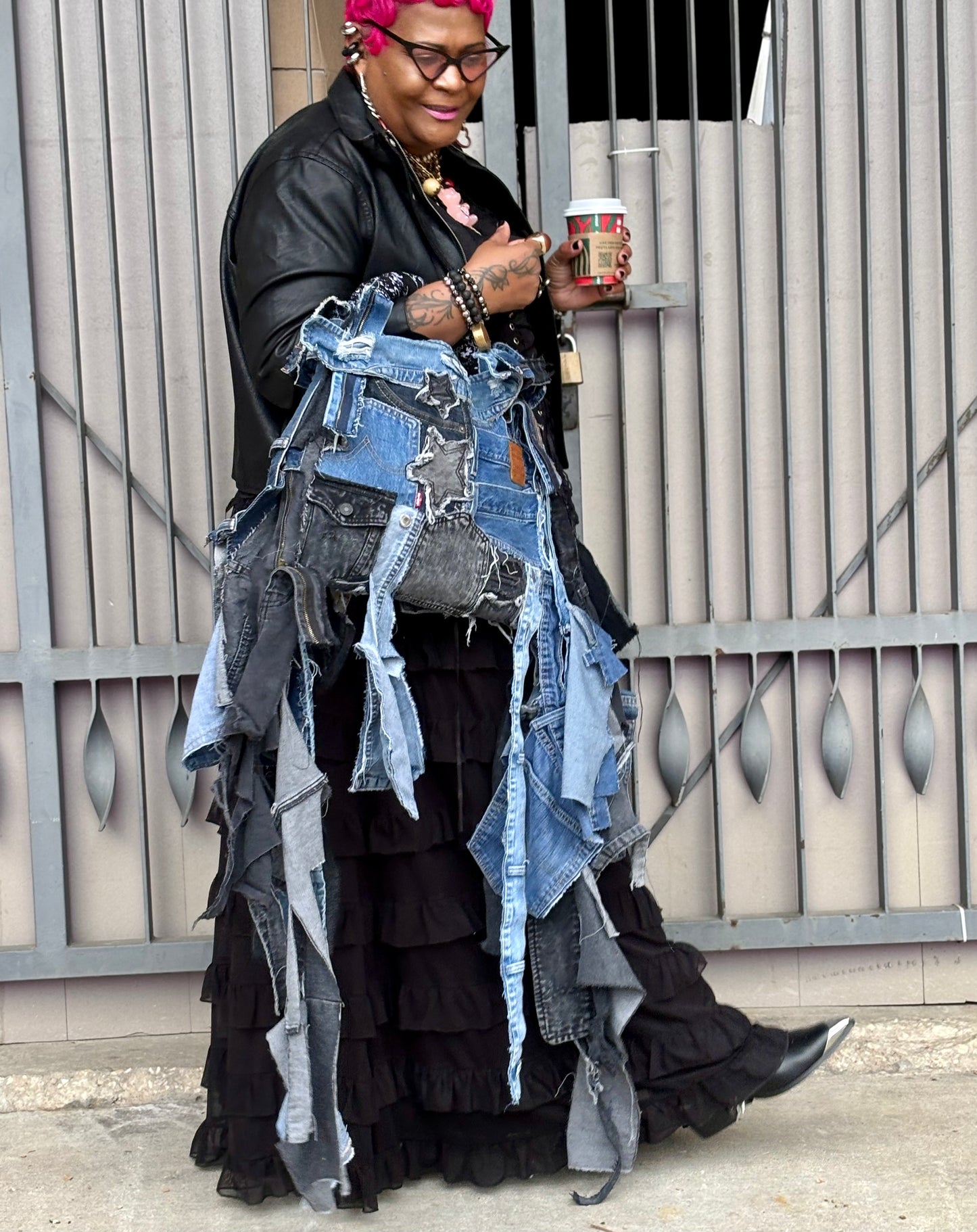 Woman holding denim bag with stars and patches , bandanna handle
