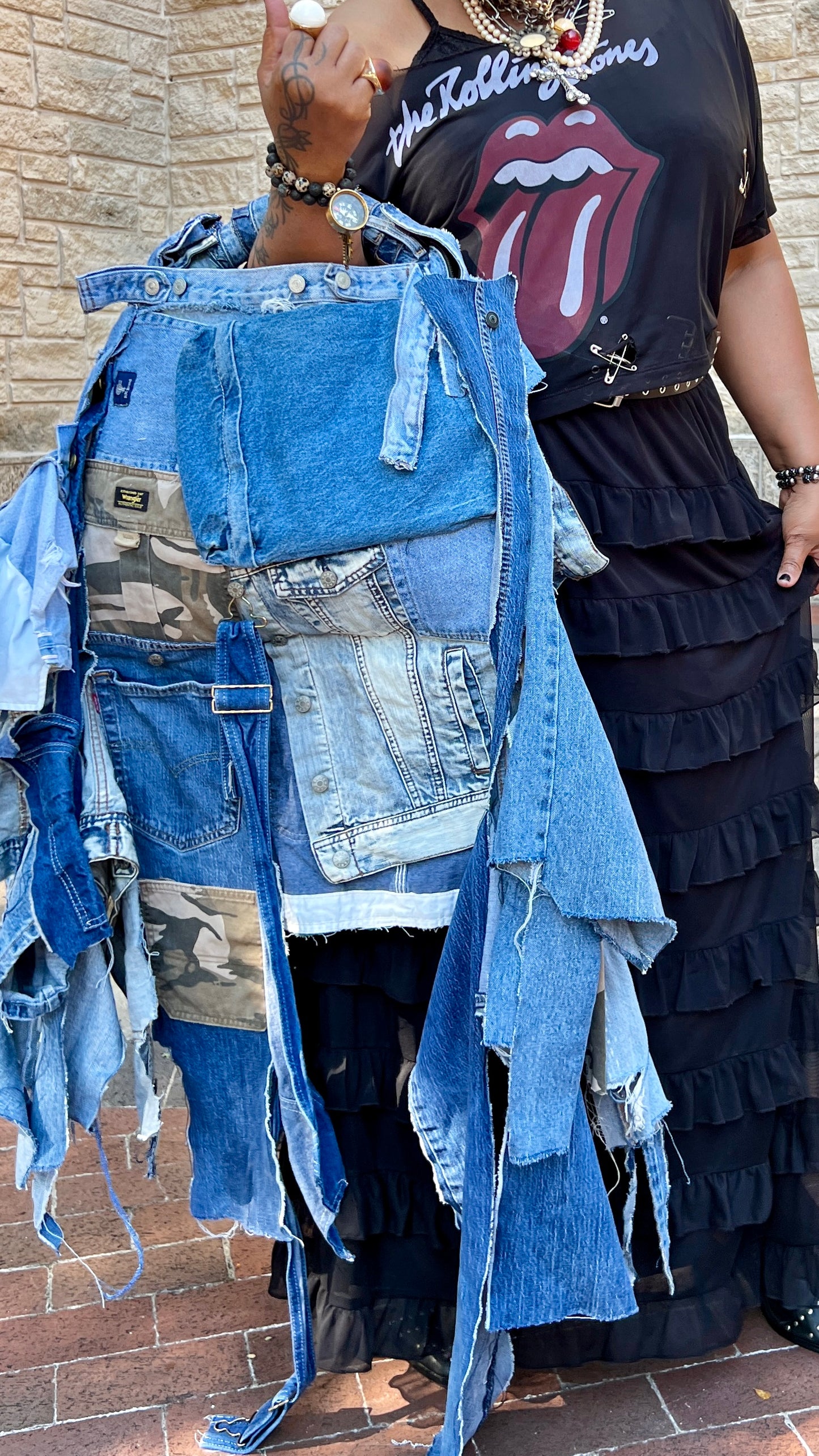 Person Styling A Ugly Denim Bag From Funky Grunge Boutique Collection Standing by Brick Wall