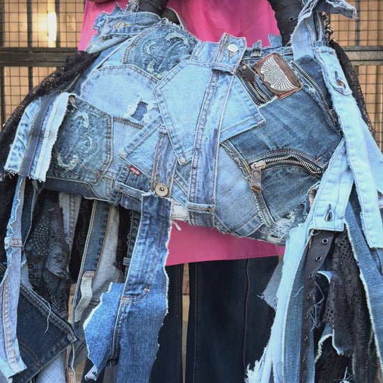 Person weaing pink to showing how to use denim bag