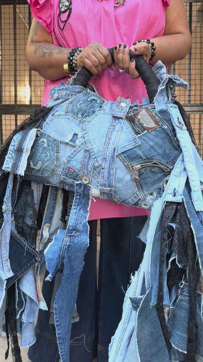 Person weaing pink to showing how to use denim bag